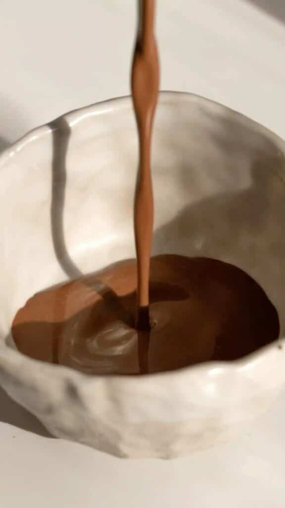 a liquid pouring into a bowl cacao